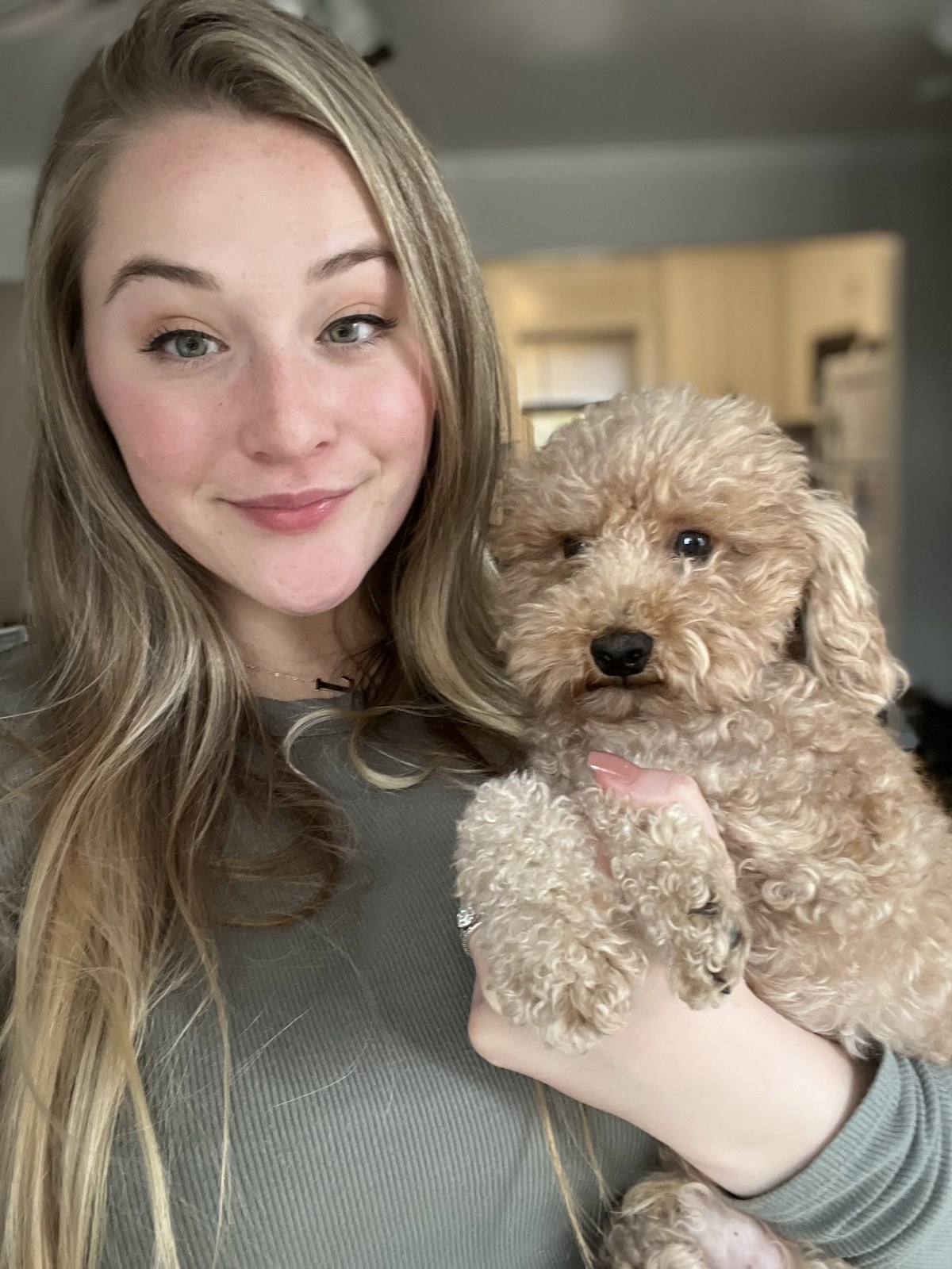 Leah, founder of Paws & Care, holding a small dog